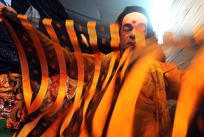 Indian performer Laxmi Narayan Jha, 77, affectionately known as ?Grandpa? prepares for a show backstage at the Maharashtra Ramlila Manch in Mumbai.