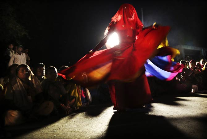 An Indian landless farmer dances to entertain the gathering as they halt for the night. ? Photo by AP