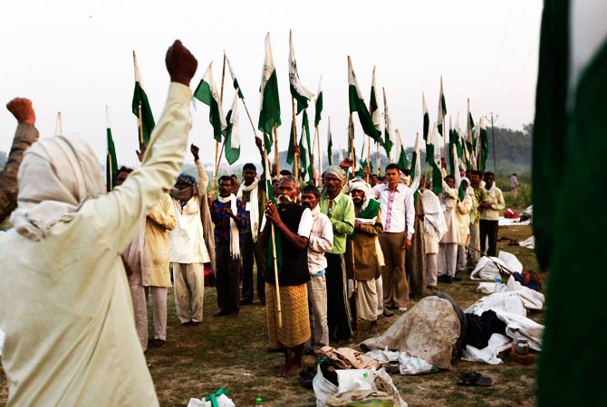 Indian landless villagers shout slogans in Agra. ? Photo by AP