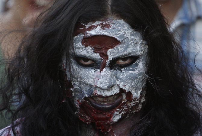 A woman dressed up as a zombie participates in a "zombie walk" in Ciudad Juarez. Children and adults dressing up as zombies took part in the "Zombie Walk Ciudad Juarez", aimed at collecting food and hygiene kits to support the community centre "Sowers of Peace and Hope", which helps children in this border city, local media reported.?Reuters Photo