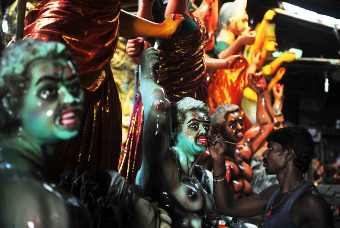 An Indian artist paints the face of a clay idol. ? Photo by AFP