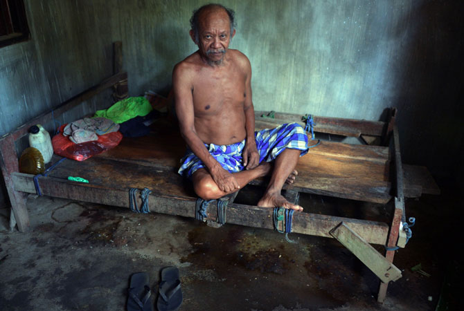 A mental disorder patient, Nengah Surung, 65, stays in his special room which design for his illness in Karangasem. This event promotes open discussions on illnesses, as well as investments in prevention and treatment services.