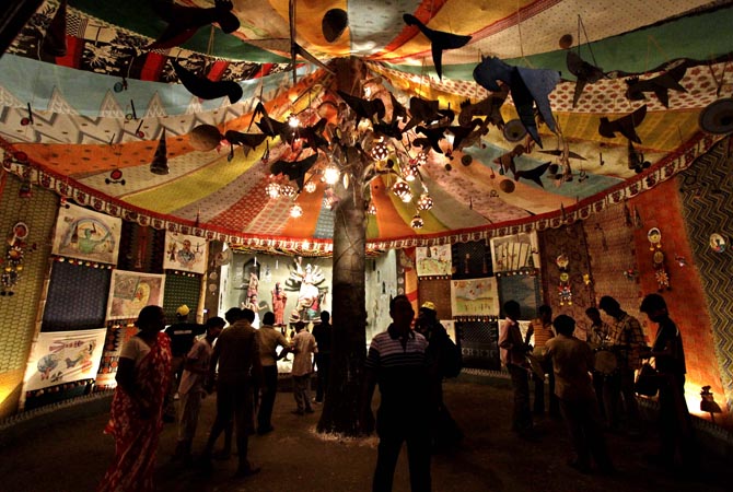 Devotees throng inside a temporary worship venue of Hindu goddess Durga on the first day of the Durga Puja festival in Kolkata, India. The five-day festival, commemorates the slaying of a demon king by lion-riding, 10-armed goddess Durga, marking the triumph of good over evil. ?AP Photo