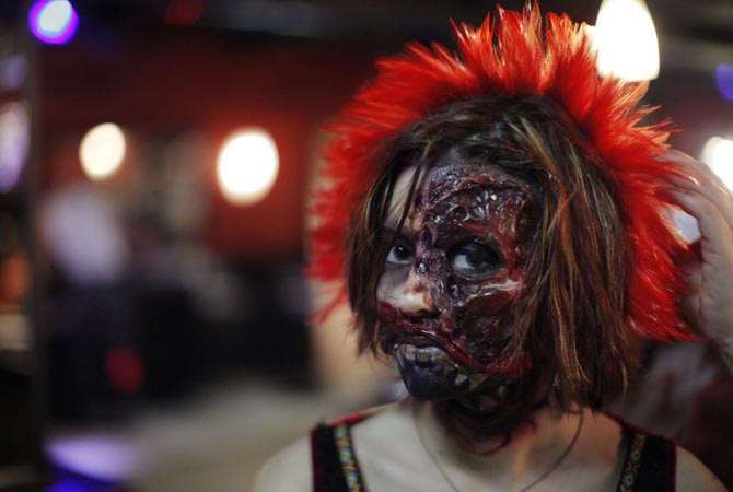 A woman dressed up as a zombie poses for a picture during an event in New York.?Reuters Photo