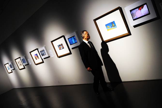A man looks at the displayed works at the preview visit to The China Art Museum in Shanghai. ? Photo by AFP