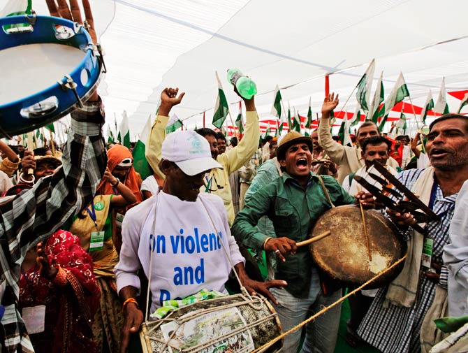 Indian landless villagers and tribal people celebrate, thousands of poor farmers have ended their march to India's capital after the government agreed to formulate a new reform policy. ? Photo by AP