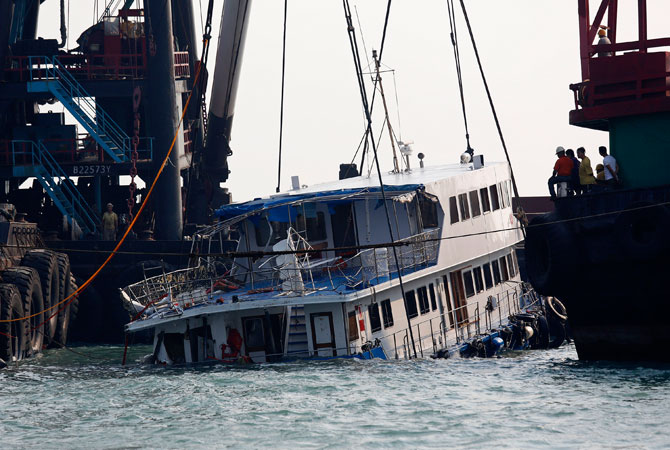 A half submerged boat is lifted by cranes Tuesday Oct. 2, 2012 after Monday night's collision near Lamma Island, off the southwestern coast of Hong Kong Island. ? Photo by AP