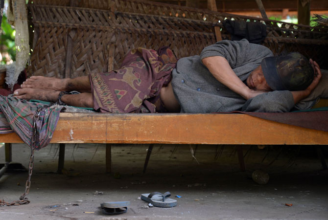 A mental disorder patient, I Ketut Lingga, 54, stays on his bed and chained by his family in Karangasem. Mental health services lack human and financial resources in many countries, particularly low and middle income countries. More funding is needed to promote mental health to increase people's awareness of the issue.