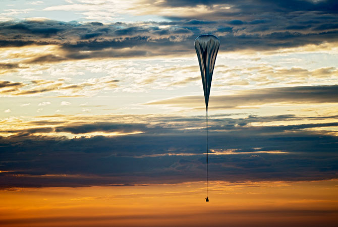 A balloon lifts up during the second manned test flight for Red Bull Stratos in Roswell, N.M. It's described as a ?40-acre dry cleaner bag,? that, when first filled, will stretch 55 stories high. On Monday, this special ultra-thin helium balloon is scheduled to liftoff from Roswell, N.M., to carry ?Fearless Felix? Baumgartner 23 miles into the stratosphere for what he hopes will be a history-making, sound barrier-breaking skydive. ? Photo by AP