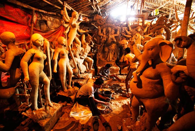 Artisans work on idols of Hindu Goddess Durga and other Hindu Gods at a workshop. ? Photo by AP