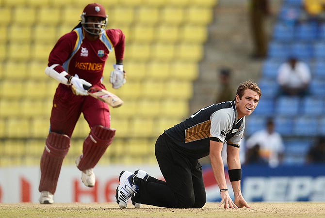 Tim Southee looks on as West Indies' Chris Gayle (L) takes a run. -Photo by Reuters