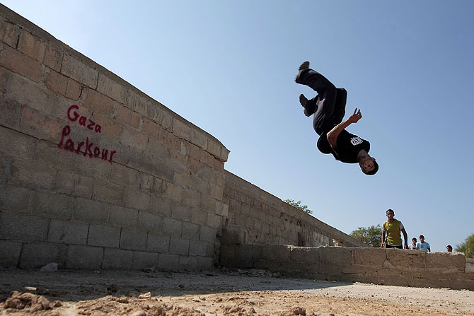 A Palestinian youth practicing his parkour skills.