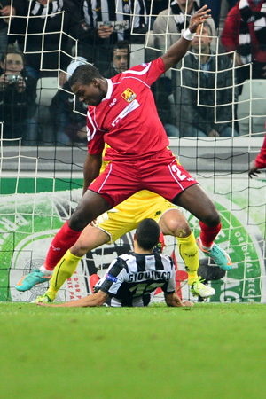 Nordsjaelland's defender Jores Okore (top) fights for the ball with Juventus' forward Sebastian Giovinco during the Champions League match between Juventus and FC Nordsjaelland on November 7, 2012 in the stadium of Alps in Turin.