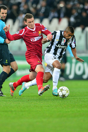 Juventus' midfielder of Chile Arturo Vidal (Right) fights for the ball with Nordsjaelland's midfielder Kasper Lorentzen during the Champions League match between Juventus and FC Nordsjaelland on November 7, 2012 in the stadium of Alps in Turin.