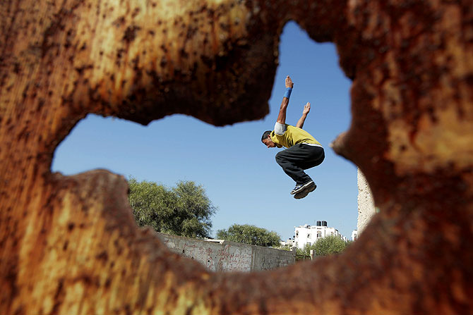 A Palestinian youth practicing his parkour skills.