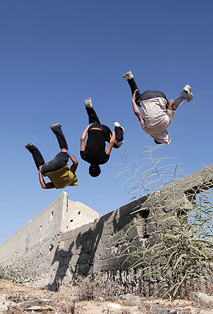 Palestinian youths practicing their parkour skills, also known as free running in the town of Khan Younis, in the southern Gaza Strip.