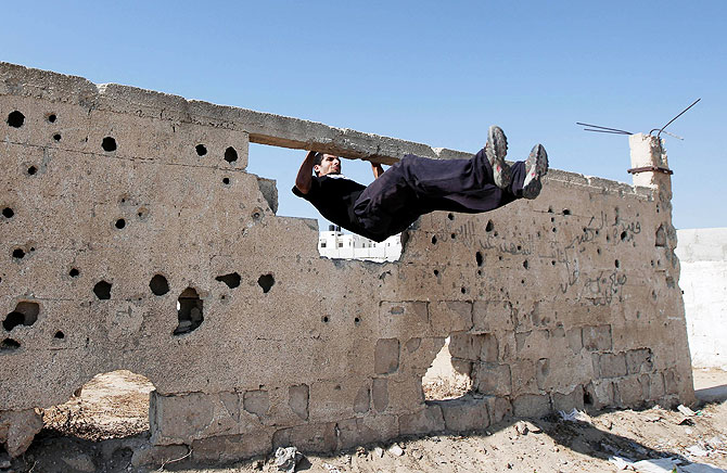 A Palestinian youth practicing his parkour skills.