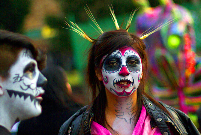 Mexican students at UNAM in Mexico City, during preparations on the eve of the Day of the Dead celebrations. The symbol most represented during the holiday in the form of masks and face paint, is the skull or calacas in colloquial terms.