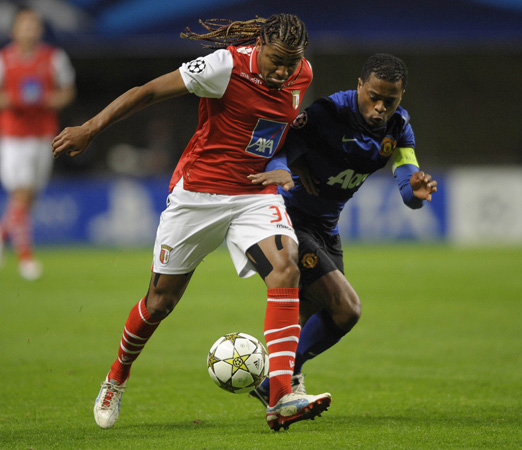 Braga's Brazilian forward Alan Silva (Left) vies with Manchester United's French defender Patrice Evra during the UEFA Champions League football match SC Braga vs Manchester United at the Municipal stadium of Braga.