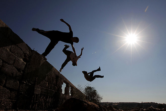 Palestinian youths practicing their parkour skills, also known as free running in the town of Khan Younis, in the southern Gaza Strip.