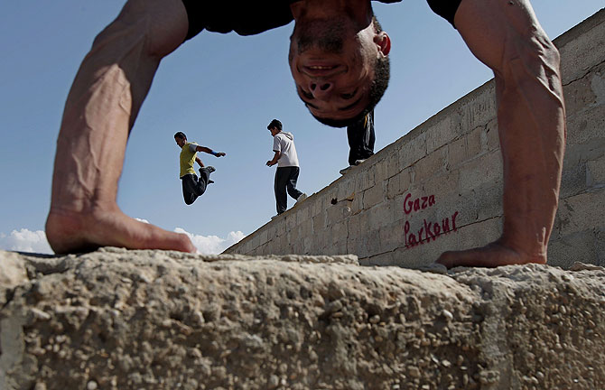 A Palestinian youth practicing his parkour skills.