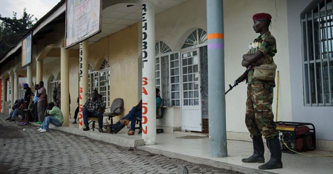 An M23 rebel soldier stands outside a shop in Goma, in the east of the Democratic Republic of Congo on Nov 28, 2012. The government accused rebels today of widespread looting in Goma as the fighters began pulling out of the strategic eastern city following diplomatic mediation to prevent the conflict spreading across the volatile region. - AFP Photo