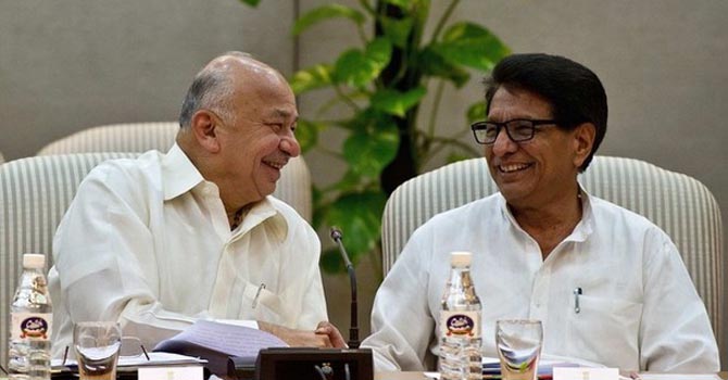 Indian Power Minister Sushilkumar Shinde and Civil Aviation Minister Ajit Singh shakes hands during a meeting in New Delhi