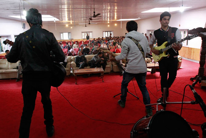 Band ?Sign - the signature of music? (L-R) guitarist Zahoor Qadir, 18, guitarist and lead singer Qassam Dar, 18, guitarist Azan Mullick, 18, and drummer Muneeb Khan, 17, (unseen) perform on stage at a college in Srinagar.