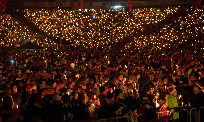 Supporters of the German second division football club FC Union Berlin attend the 10th Christmas singing at Stadium Alte Foersterei in Berlin, on December 23, 2012. For two hours, more than 20000 people sang Christmas songs. ? Photo by AFP