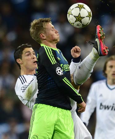 Real Madrid's Portuguese forward Cristiano Ronaldo (Left) vies with Ajax Amsterdam's Danish forward Viktor Fischer (Right) during the UEFA Champions League Group D football match Real Madrid vs Ajax Amsterdam at the Santiago Bernabeu stadium in Madrid.