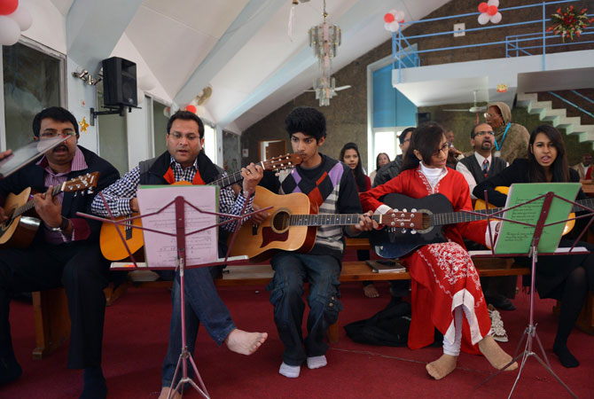 Pakistani Christians sing hymns during Christmas mass at the Fatima Church in Islamabad on December 25, 2012.