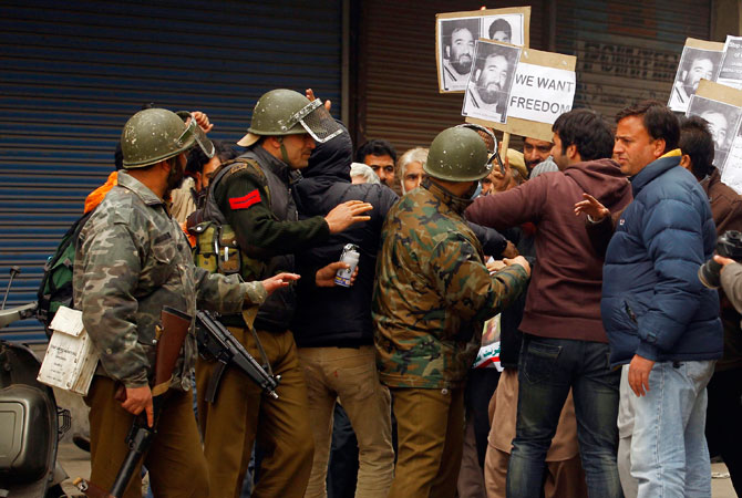 Indian police detain Chief of Jammu Kashmir Liberation Front (JKLF) Yasin Malik, who is carrying a placard reading ?We want freedom?, and his supporters in Srinagar December 7, 2012.