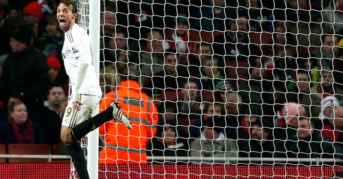 Swansea's Miguel Michu celebrates after scoring against Arsenal during their English Premier League match at The Emirates Stadium. – Photo by Reuters