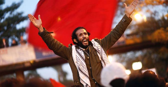 An Egyptian opponent of President Mohammed Morsi shout slogans during a march to the Presidential palace on Dec 6, 2012 in Cairo. - AFP Photo/File