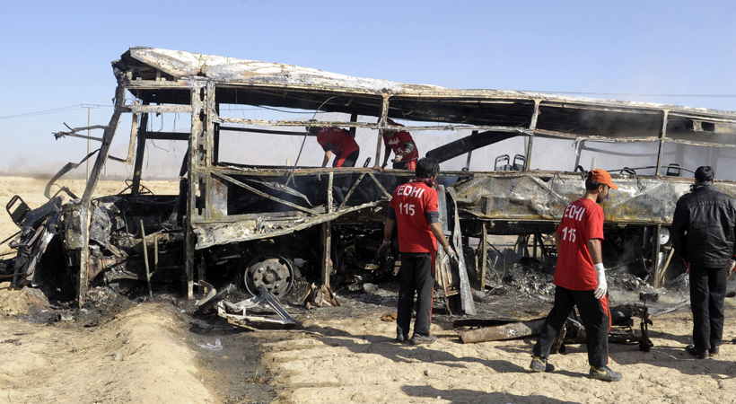 Pakistani volunteers search for victims in a destroyed pilgrims bus at the site of a car bomb attack in Mastung some 30 kilometres south of Quetta. A car bomb attack on buses carrying Shiite Muslim pilgrims to Iran has killed 19 people and injured 25 in Pakistan's insurgency-hit southwest on December 30, officials said.?Photo by AFP