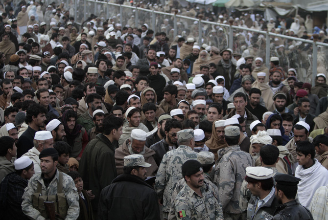 Afghan people stand in the main border crossing of Torkham, between Afghanistan and Pakistan east of Kabul. Today is the second day that Torkham the main border between Afghanistan and Pakistan is closed by Pakistani authorities, hundreds of trucks, cars plus several hundred people including, women, children, elders and especially sick people who are going from Afghanistan to Pakistan for treatment are waiting for the border to open, there are reports of at least three civilians being killed in Afghanistan side and