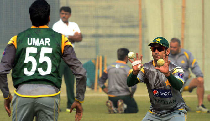 Mohammad Hafeez and Umar Gul take part in fielding practice. ? Photo by AFP