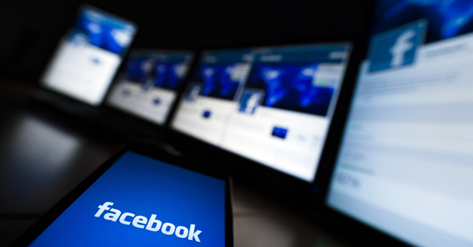 Photo illustration shows the loading screen of the Facebook application on a mobile phone. — File Photo
