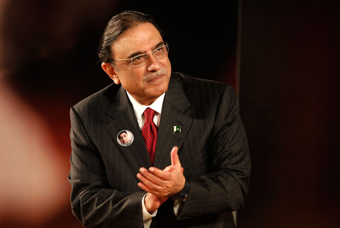 Pakistan's President Asif Ali Zardari attends the event ?Stand up for Malala, Girls' education is a right!? during the United Nations Human Rights Day at the Unesco headquarters in Paris December 10, 2012. A special tribute was paid to Malala Yousafazi, the teenage Pakistani schoolgirl shot by the Taliban after advocating education for girls, at the British hospital where she is being treated. The poster in the background shows Malala Yousafazi.