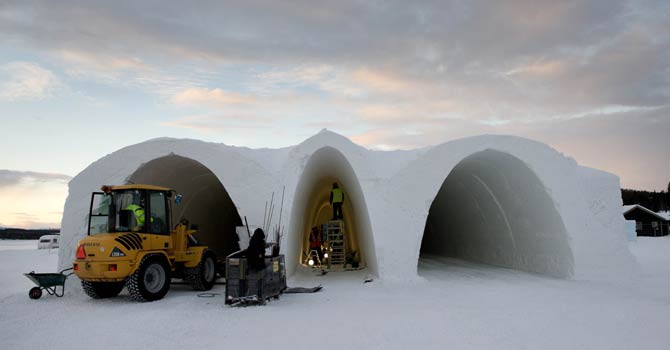 People work at the construction site of the new Ice Hotel in the village of Jukkasjarvi, near Kiruna, in Swedish Lapland on Nov 16, 2012. The Ice Hotel gets a new design and is reconstructed every year, and is dependent upon constant sub-freezing temperatures during construction and operation. - AFP Photo