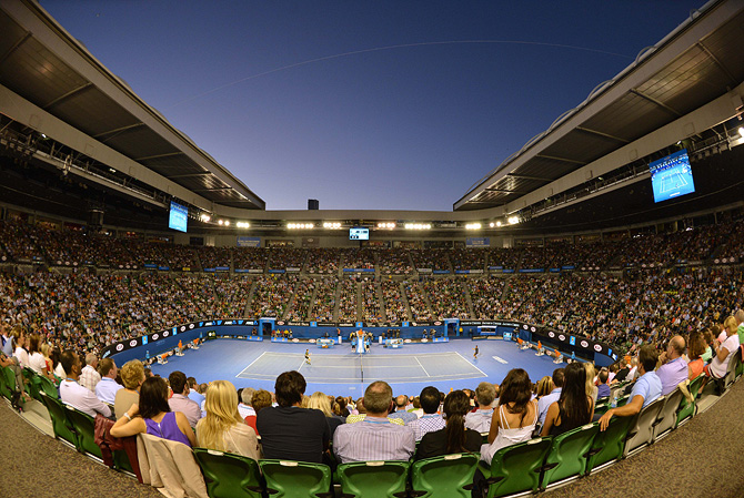 Supporters watch the the men's singles final between Serbia's Novak Djokovic and Britain's Andy Murray on day 14 of the Australian Open tennis tournament in Melbourne on January 27, 2013. – Photo by AFP
