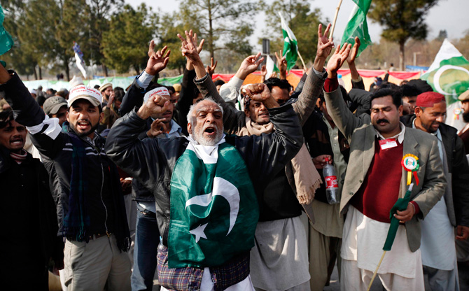 Supporters of Muhammad Tahirul Qadri, shout slogans during a protest in Islamabad January 14, 2013. Thousands of Pakistanis converged on the capital Monday to join a march planned by Qadri calling for the indefinite delay of elections and a crackdown on government corruption and inefficiency. ? Photo by Reuters