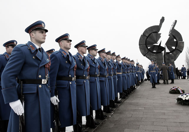 Serbian military honor guards stand to attention during commemorations for victims of the Holocaust at a monument erected in the former World War II Nazi concentration camp of Sajmi?te in Belgrade, Serbia. ?Photo by AP