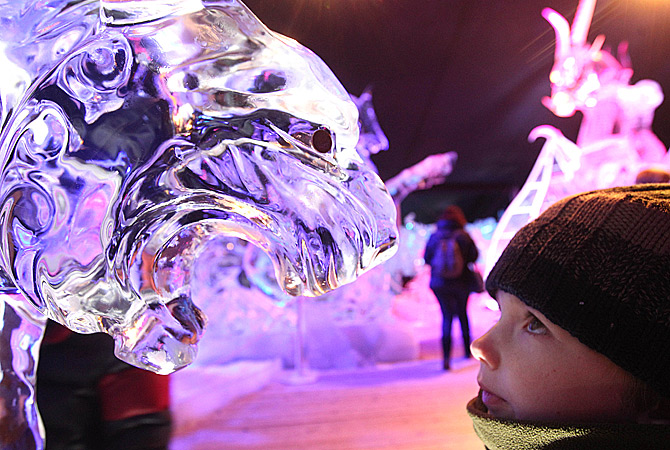 A boy looks at a tiger made of ice, at the Ice Sculpture festival in Bruges, Belgium, Friday, January 4, 2013. ? AP Photo