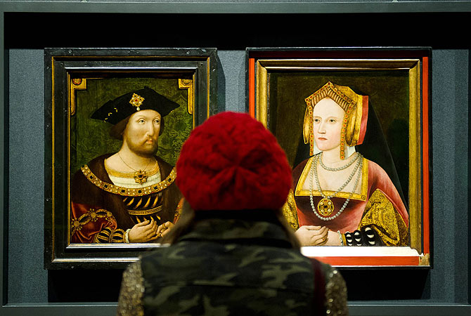 A woman looks at portraits of Britain's King Henry VIII and Catherine of Aragon, displayed together for the first time in nearly 500 years, at the National Portrait Gallery, central London. Discovered in Lambeth Palace, the portrait of Catherine of Aragon had been painted over with a picture of the King's last wife Catherine Parr but experts suspected that there may be more to the picture due to similarities with other known paintings of Catherine of Aragon. ? AFP Photo
