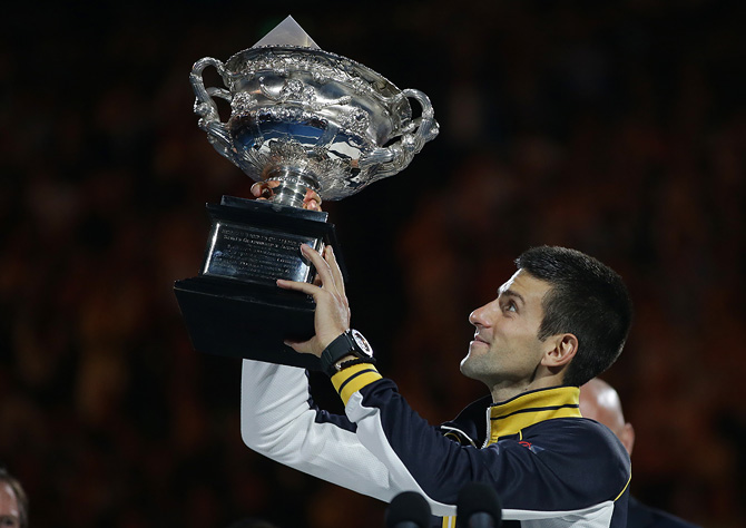 Serbia's Novak Djokovic holds his trophy aloft after defeating Britain's Andy Murray in the men's final at the Australian Open tennis championship in Melbourne, Australia, Sunday, Jan. 27, 2013. – Photo by AP
