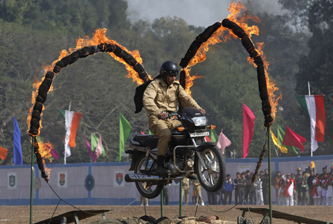 An Indian paramilitary trooper performs a stunt on his motorcycle during the Republic Day parade in Agartala, capital of northeast state Tripura.