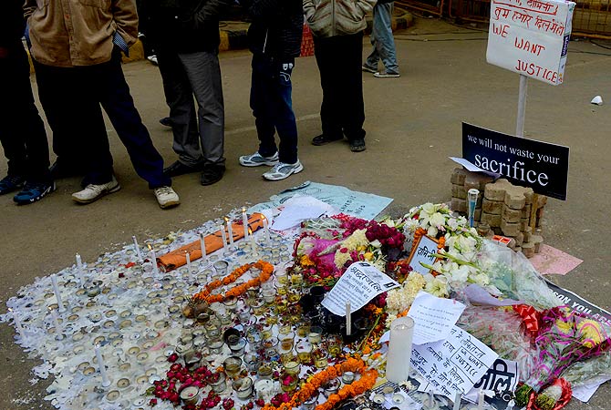 Indian protestors look at a display of lighted candles left in memory of a gangrape victim in New Delhi on January 2, 2013. ? AFP Photo
