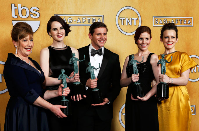 Cast members of the TV drama ?Downton Abbey? hold their award for ?Outstanding Performance by an Ensemble in a Drama Series? backstage. ?Photo by Reuters