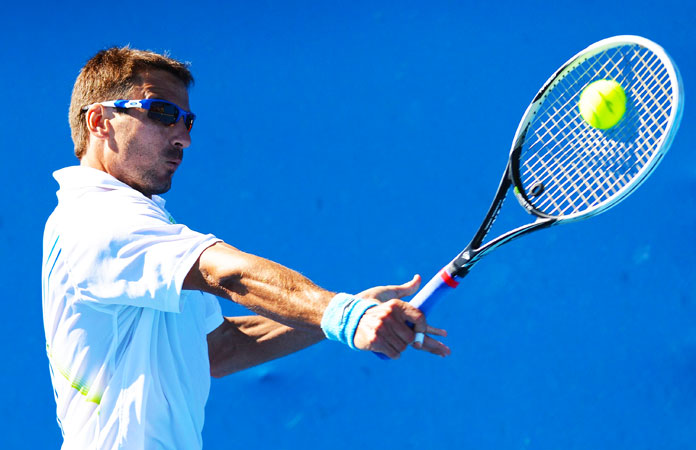Spain's Tommy Robredo hits a return against Canada's Jesse Levine during their men's singles first round match.